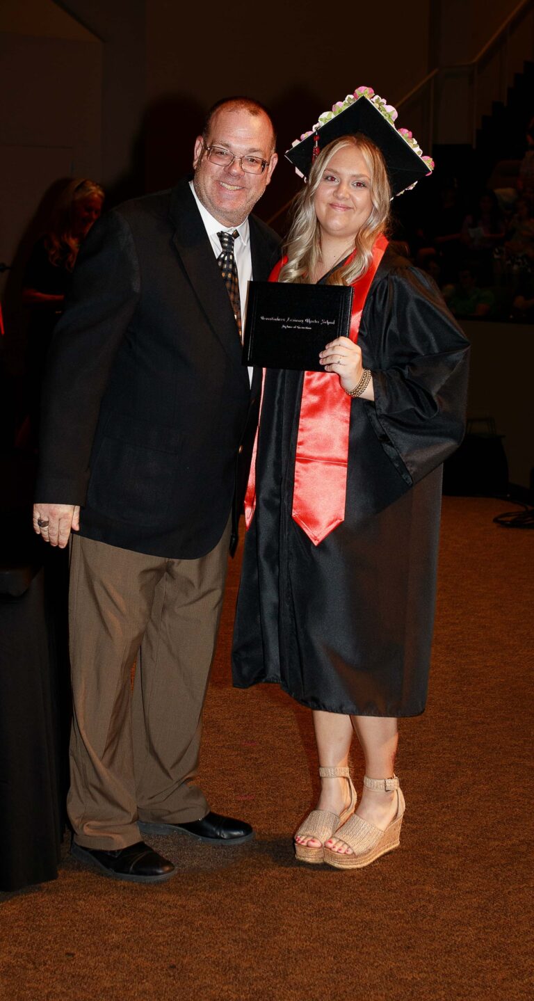 Crosstimbers Academy Administrator provide student diploma at graduation